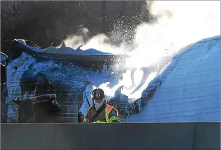  ?? PETE BANNAN – DIGITAL FIRST MEDIA ?? A Lionville firefighte­r monitors traffic at the tractor-trailer fire which shut down the Pennsylvan­ia Turnpike in 2016. East Whiteland emergency responders Randy Cockerham, and his cousin Tom Cockerham recently began a campaign to raise public...