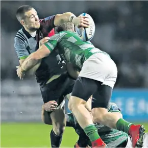 ??  ?? Sleight of hand: Mike Brown gets his offload away despite being tackled