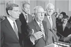  ?? MICHAEL REYNOLDS, EPA ?? Senate Majority Leader Mitch McConnell, center, struggled to respond to the president’s remarks on the weekend’s violence.