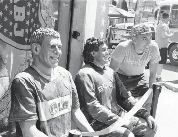  ?? Juan Ignacio Roncoroni EPA / Shuttersto­ck ?? A FAN in Buenos Aires poses with figures of former Boca Juniors stars Martin Palermo, left, and Maradona, who is revered in his country. Maradona was kicked out of his final World Cup in 1994 for a positive drug test.