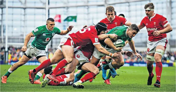  ??  ?? Hard drive: Jordan Larmour powers his way through the Welsh defence to score Ireland’s first try and (below) Andy Farrell