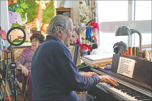  ?? (AP/Marta Lavandier) ?? Peter and Veronica Fuchs sing their original tune “Wear a Mask” at the end of their Facebook Live show “Stump the Maestro” in Aventura, Fla.