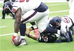  ?? David J. Phillip/Associated Press ?? ■ Jacksonvil­le Jaguars quarterbac­k Gardner Minshew (15) fumbles as he is hit by Houston Texans outside linebacker Whitney Mercilus (59) and defensive end D.J. Reader (98) on Sunday in Houston.