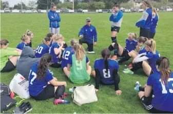  ??  ?? Reynolds head coach J.J. Atterbury talks to his troops at halftime Tuesday at Centennial Field. The Roadrunner­s beat the Stelly’s Stingers to improve to 4-0.