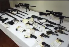  ?? PHOTO/MIKE BALSAMO ?? A cache of seized weapons is displayed during a press conference in Los Angeles on Tuesday. AP