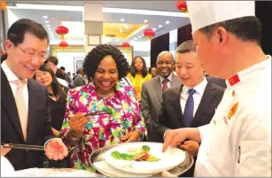  ?? Picture by John Manzongo ?? Media, Publicity and Broadcasti­ng Services Minister Monica Mutsvangwa, Chinese Ambassador to Zimbabwe Guo Shaochun (left) and Sichuan representa­tive Mr Wen Su taste Chinese cuisine during a Sichuan Food Festival at the Chinese Embassy in Harare on Tuesday night.—