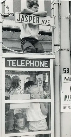  ??  ?? The Klondike Days Parade was the event of the summer in Edmonton decades ago. ABOVE: Children crowded a phone booth to take in the 1964 edition. BELOW: A steel drum band played during the 1971 parade.