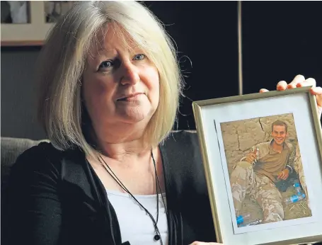  ?? Picture: Dougie Nicolson. ?? June Black with her favourite photo of her soldier son Aaron, who committed suicide.