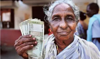  ?? K.V.S. GIRI ?? An old woman showing the pension money she received at a ward secretaria­t in Vijayawada. When N. Chandrabab­u Naidu had formed the government in 2014, he increased the old age pension from ₹200 to ₹1,000 and at present Y.S. Jagan Mohan Reddy government is paying ₹3,000 to them.