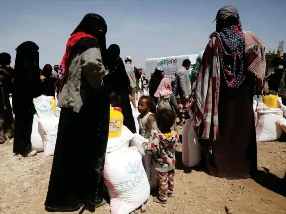  ?? (EPA) ?? Displaced people get food rations ahead of a donors conference on Yemen humanitari­an crisis