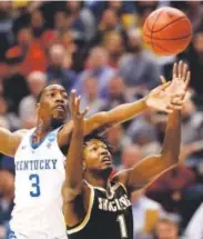  ?? The Associated Press ?? Kentucky’s Bam Adebayo and Wichita State’s Zach Brown reach for a rebound Sunday during their second-round game. Jeff Roberson,