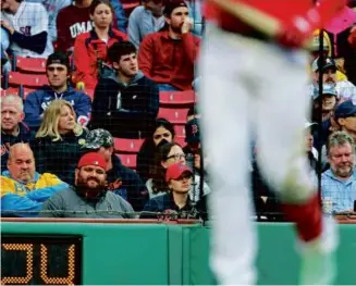  ?? JIM DAVIS/GLOBE STAFF ?? The home team didn’t lift many spirits in the stands at an unseasonab­ly cool Fenway Park, beaten for the third straight game by the Rays.