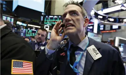  ??  ?? Tension on the floor of the New York Stock Exchange on New Year’s Eve. Photograph: Richard Drew/AP