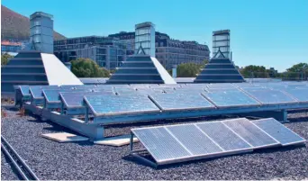  ??  ?? Solar panels on the rooftop of a building in Cape Town, South Africa