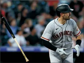  ?? MATTHEW STOCKMAN/GETTY IMAGES ?? Curt Casali of the San Francisco Giants hits a two-run home run against the Rockies on Monday in Denver, Colo.