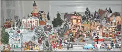  ??  ?? Anita Stewart says her tiny Christmas village includes a clock tower, Romulus and Remus statue, train, seashore, and even a Christmas dog parade. She invites family and friends to special open houses to enjoy the spectacle.
Contribute­d photos