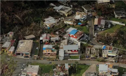  ??  ?? Buildings damaged by Hurricane Maria in Lares, Puerto Rico, in 2017. The hurricane killed thousands of people. Photograph: Lucas Jackson/Reuters