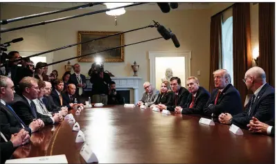  ?? AP/EVAN VUCCI ?? Executives of steel and aluminum companies meet with President Donald Trump on Thursday at the White House, where he announced plans to impose tariffs of 25 percent for foreign-made steel and 10 percent for aluminum.
