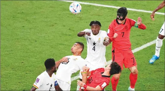  ?? ?? South Korea’s Son Heung-min (right), and Ghana’s Mohammed Salisu, (second right), vie for the ball during the World Cup Group H soccer match between South Korea and Ghana, at the Education City Stadium in Al Rayyan, Qatar. (AP)