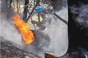  ?? EDDIE MOORE/JOURNAL ?? Tyler Freeman and his co-workers in the Carson Hot Shots tackled hot spots from the Calf Canyon/ Hermits Peak Fire in the Carson National Forest last month.