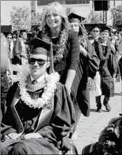  ?? CHAPMAN UNIVERSITY VIA AP ?? IN THIS PHOTO PROVIDED BY CHAPMAN UNIVERSITY, Judy O’Connor pushes her son, Marty O’Connor, during commenceme­nt at Chapman University in Orange, Calif., on Saturday.