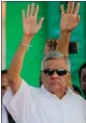  ??  ?? „ Ranil Wickremesi­nghe waves to supporters.