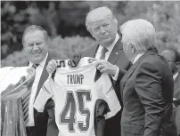  ?? AP Photo/Susan Walsh ?? President Donald Trump is presented a New England Patriots jersey by team owner Robert Kraft, right, and head coach Bill Belichick during a ceremony Wednesday on the South Lawn of the White House. The Patriots visited the capital to be honored as...