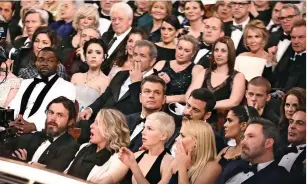  ??  ?? It gradually becomes clear to guests that something has gone very wrong. Confusion and shock is etched on the faces of such Hollywood royalty as Mel Gibson, centre, Sting and Trudie Styler, top right, Matt Damon, second row, and at the front Michelle...