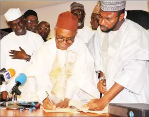  ?? Photo: NAN ?? From left: Deputy Governor of Kaduna State, Mr Bala Bantex; Governor Nasir El-Rufai and Speaker Kaduna State House of Assembly, Alhaji Aminu Shagali, at the signing of the 2018 State Appropriat­ion Bill into law in Kaduna yesterday