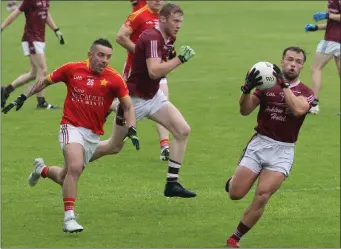  ??  ?? Conor Carty gathers possession for Castletown as Ricky Fox (Starlights) gives chase.