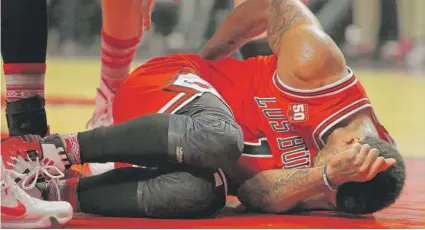  ?? | JONATHAN DANIEL/ GETTY IMAGES ?? Oft- injured Derrick Rose fell to the floor Saturday night against the Houston Rockets but got back up.