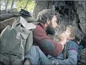  ?? Jonny Cournoyer Paramount Pictures ?? DIRECTOR, writer and co-star John Krasinski, left, with Noah Jupe in the horror film “A Quiet Place.”