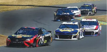  ?? ASSOCIATED PRESS FILE PHOTO ?? Martin Truex Jr. (78) leads Chase Elliott and other NASCAR drivers through a turn during last Sunday’s Cup Series event at Sonoma Raceway in California. Truex won the race, and Elliott finished fourth.