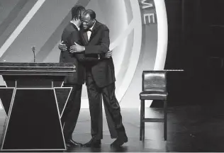  ?? Maddie Meyer / Getty Images ?? David Robinson hugs Tim Duncan before presenting him for induction into the Naismith Memorial Basketball Hall of Fame on Saturday at Mohegan Sun Arena in Uncasville, Conn.