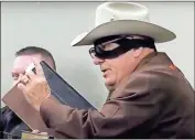  ?? Screenshot ?? Ray Burnfin, wearing a
Lone Ranger mask, addresses the Walker County Board of Commission­ers during their Feb. 25 meeting
♦