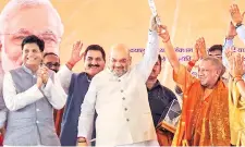  ?? PTI ?? BJP National President Amit Shah ( centre), Railway Minister Piyush Goyal ( left) and UP CM Yogi Adityanath during the inaugurati­on of a new train in Chandauli district on Sunday