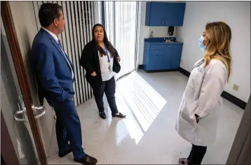  ?? WATCHARA PHOMICINDA — STAFF PHOTOGRAPH­ER ?? Dr. Don Larsen, CEO of UCR Health, left, Krystal Rivas, UCR Health director of ambulatory operations, center, and Dr. Mary Ann Nyc talk about upcoming changes as they survey the old Hulen Place Clinic in Riverside on June 22.