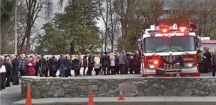  ??  ?? Civilians queue up near Ladder 5, to enter Mercadante Funeral Home for the wake of Lt. Jason Menard on Sunday.