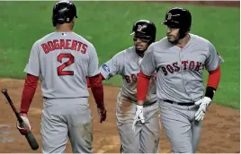  ?? STAFF PHOTO BY CHRISTOPHE­R EVANS ?? IT ALL COMES TOGETHER: Mookie Betts (center) celebrates with Xander Bogaerts after he scored on a sacrifice fly by J.D. Martinez (right) in the Red Sox’ 16-1 romp in last night’s Game 3.