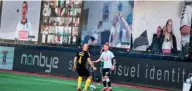  ?? (AFP) ?? Players vie for the ball as fans are streamed live on to the screens on the sidelines during the 3F Super League football match between AGF and Randers FC at Ceres Park in Aarhus, Denmark, on Thursday.