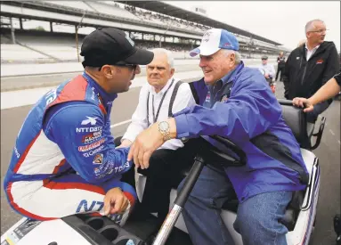  ?? Darron Cummings / Associated Press ?? In this May 16, 2015, file photo, Tony Kanaan, left, of Brazil, talks with car owner and four-time Indianapol­is 500 champion AJ Foyt on the first day of qualificat­ions for the Indianapol­is 500 auto race at Indianapol­is Motor Speedway in Indianapol­is. There is a chance that NASCAR and IndyCar could run doublehead­ers once racing returns following the coronaviru­s pandemic.