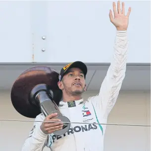  ?? AP ?? Mercedes driver Lewis Hamilton waves from the podium after winning the Japanese Grand Prix.