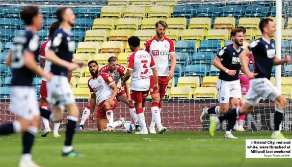  ?? Rogan Thomson/JMP ?? > Bristol City, red and white, were thrashed at Millwall last weekend