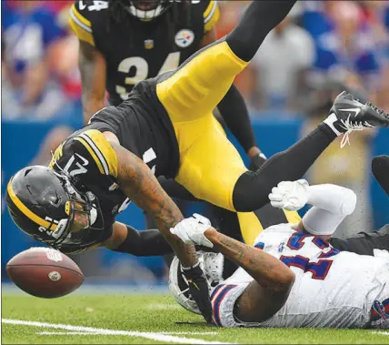  ?? JOSHUA BESSEX / ASSOCIATED PRESS ?? Pittsburgh Steelers cornerback Tre Norwood (21) breaks up a pass intended for Buffalo Bills wide receiver Gabriel Davis (13) during the second half of their game Sunday in Orchard Park, N.Y.