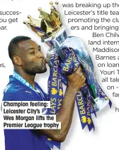  ??  ?? Champion feeling: Leicester City’s Wes Morgan lifts the Premier League trophy