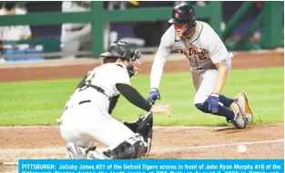  ??  ?? PITTSBURGH: JaCoby Jones #21 of the Detroit Tigers scores in front of John Ryan Murphy #18 of the Pittsburgh Pirates during the tenth inning at PNC Park on August 7, 2020 in Pittsburgh, Pennsylvan­ia. —AFP