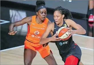  ?? MIKE CARLSON/AP PHOTO ?? Las Vegas Aces’ A’ja Wilson, right, drives against Connecticu­t Sun’s Beatrice Mompremier during the second half of a WNBA game on Thursday night in Bradenton, Fla.