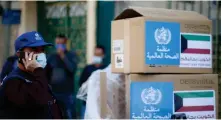  ?? Reuters ?? Abdelnaser Soboh, a WHO official, stands next to boxes containing ventilator­s donated by Kuwait, in Gaza City on Sunday.