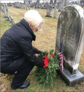  ?? ERIC DEVLIN - FOR MEDIANEWS GROUP ?? Suzanne Johnston, of Ambler, a member of the Towamencin Chapter of the Daughters of the American Revolution, lays a wreath at the headstone of a veteran in Wentz’s United Church of Christ cemetery Saturday.