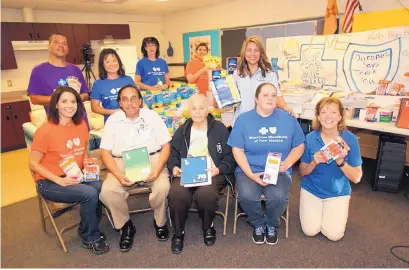  ??  ?? Blue Cross Blue Shield of New Mexico employees display at Duranes Elementary School some of the supplies they gathered for elementary students in need during the company’s annual Operation Back to School campaign.